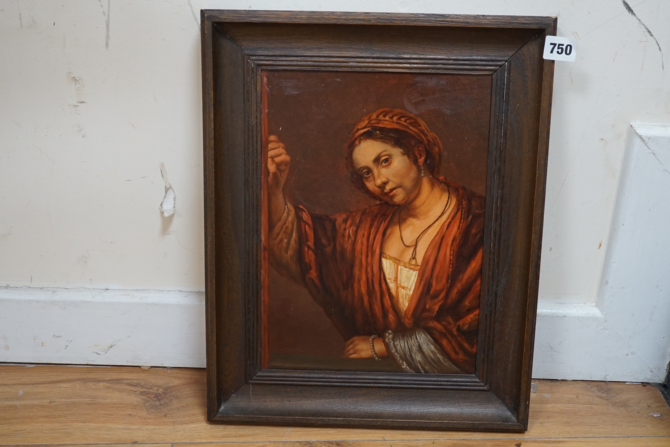 After Rembrandt (Dutch, 1606-1669), oil on board, Portrait of a woman in a doorway, indistinctly signed upper right, 31 x 23cm. Condition - fair to good